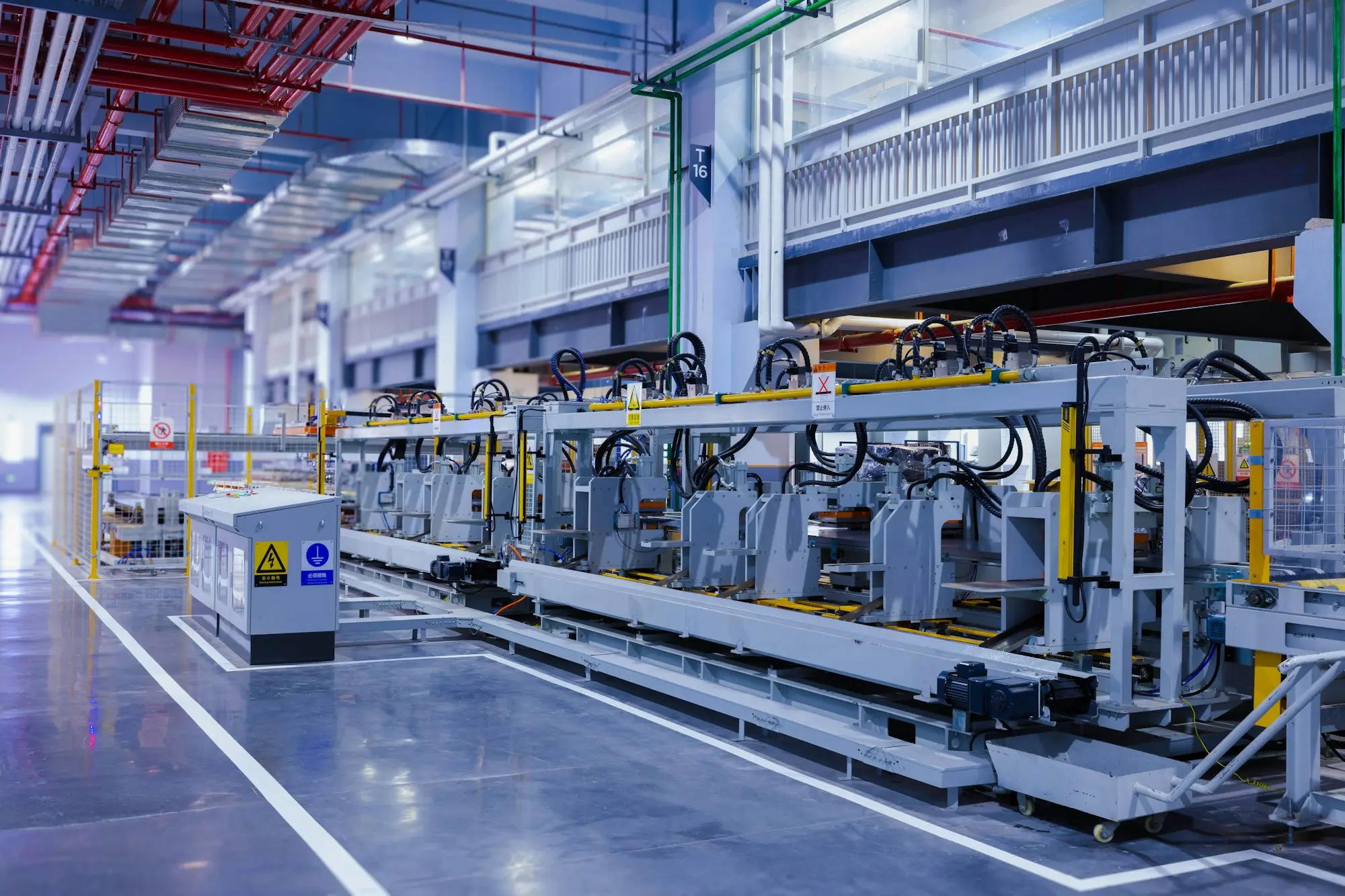 An automated assembly line with machinery in a large manufacturing hall
